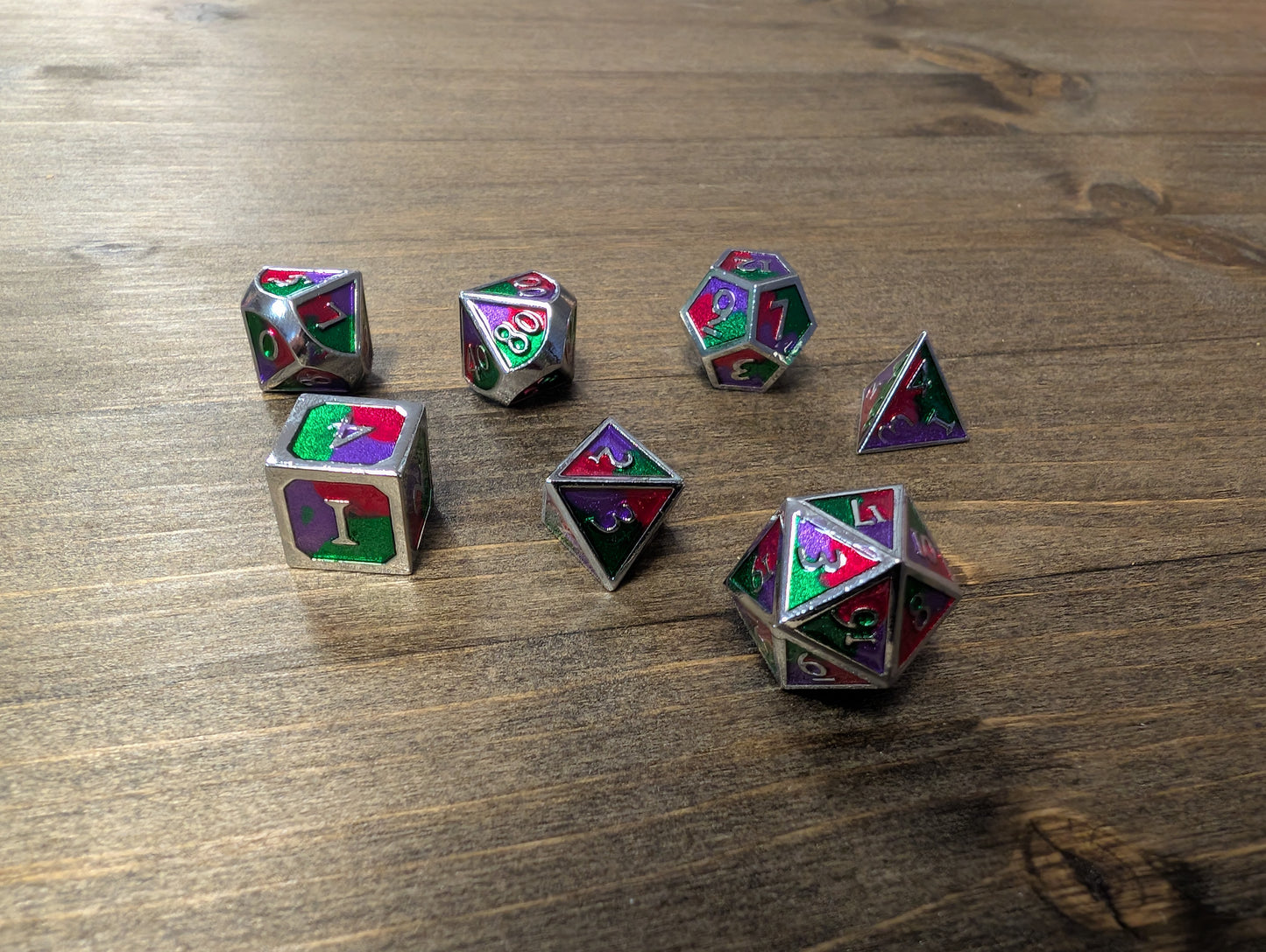 Green/purple/red set of 7 metal dice w/ silver numbers