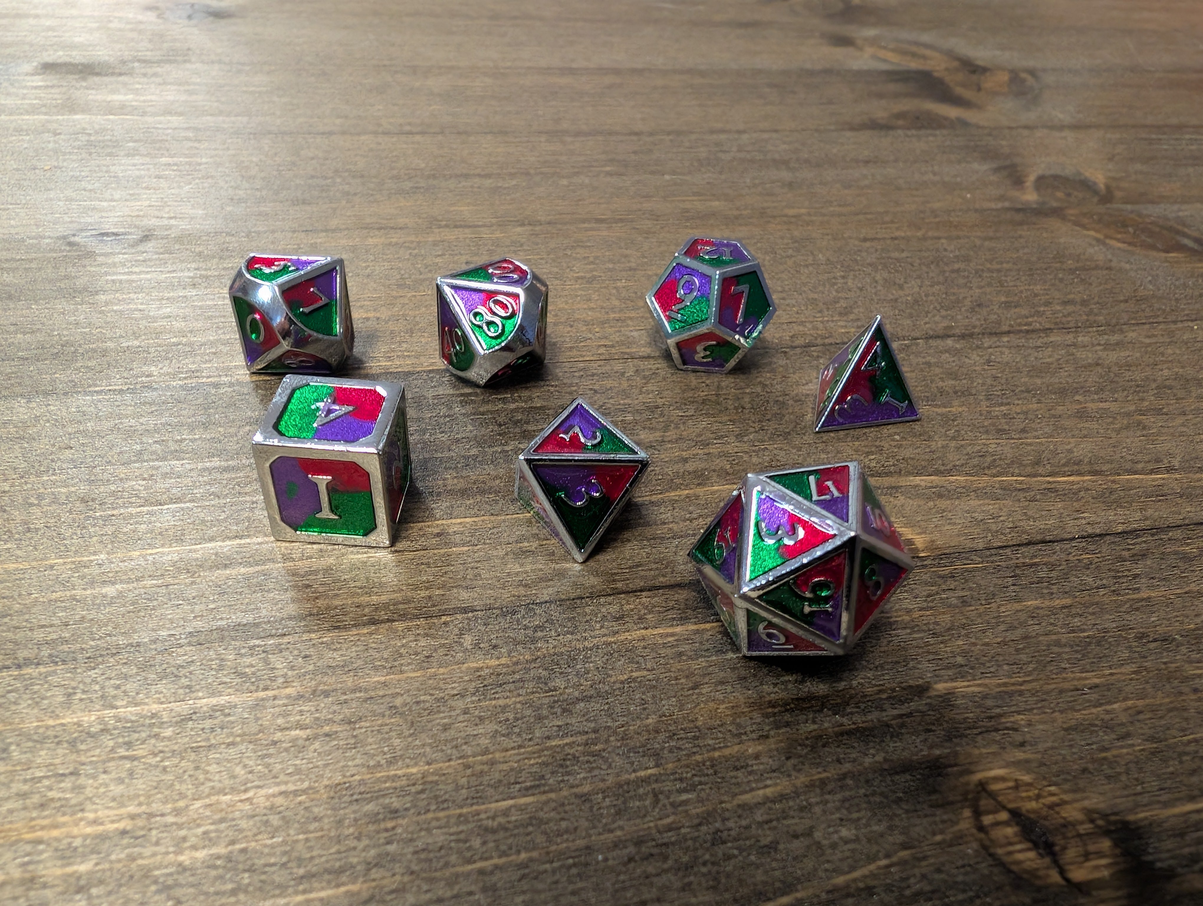 Green/purple/red set of 7 metal dice w/ silver numbers